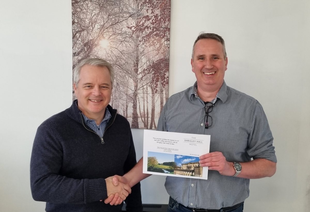 Monarch being presented with the winning golf voucher