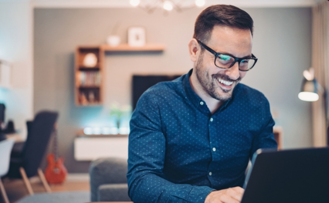 Trade Union webinar: man smiling sitting at laptop